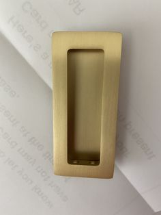 an open brass door handle on a white wall