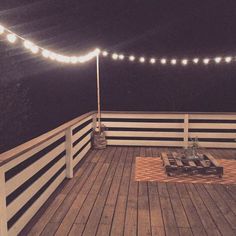 the deck is lit up with string lights