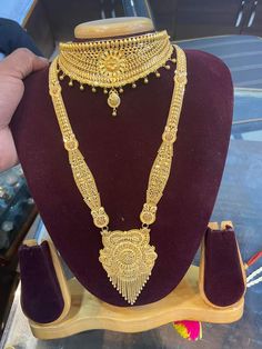 a gold necklace on display in a store