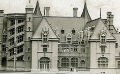 an old black and white photo of a large castle like building with turrets on top