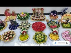 a table topped with lots of different types of cakes and flowers on top of it