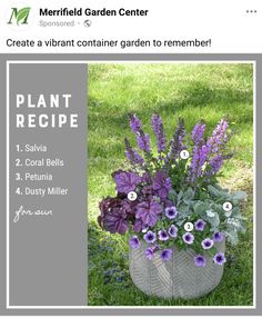 a planter filled with purple flowers sitting in the grass