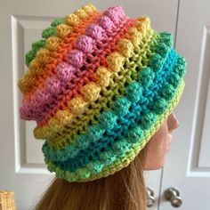 a woman wearing a multicolored crocheted hat