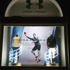 an advertisement for under armour on display in a store window