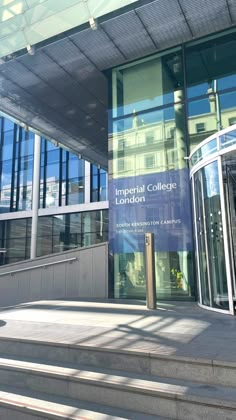 an entrance to the imperial college of london with steps leading up to it and glass windows