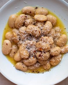 a white plate topped with pasta covered in sauce