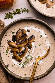 two bowls filled with soup and topped with mushrooms