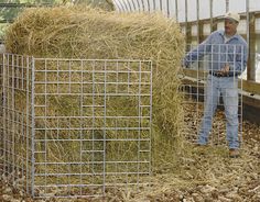 a man standing in front of a pile of hay next to a metal container filled with straw