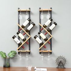 two wooden wine racks holding bottles and glasses