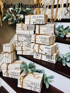 wooden boxes are stacked on the stairs with greenery tied around them and labeled with names that read, lady mercantile