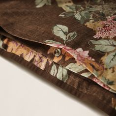 the fabric is brown and has flowers on it