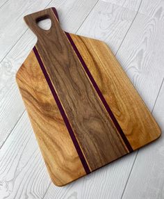 a wooden cutting board sitting on top of a white floor