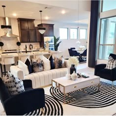 a living room filled with black and white furniture