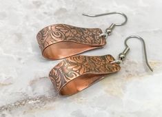 We are still taking Christmas orders until December 10th. Order early so your items arrive on time. 1.5 inch copper hoop earrings that dangle from surgical steel ear hooks. These earrings feature a tooled leather design that has been embossed on solid copper. Perfect for every day and those summer and fall nights out. These are light enough to wear all day but you will know they are there. The earrings are 8mm wide and dangle from the hooks at almost 2 inches long. Wear with jeans and a tshirt o Etched Copper Jewelry, Hammered Copper Earrings, Unique Hoop Earrings, Raw Stone Earring, Copper Jewellery, Crescent Earrings, Contemporary Earrings, Artisan Earrings, Large Hoop Earrings