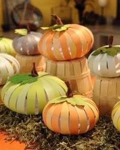 paper mache pumpkins are sitting on the ground