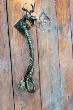 a metal hook on the side of a wooden door