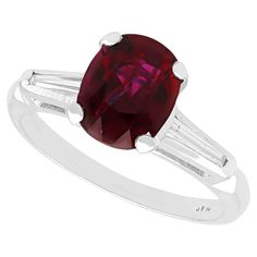 A fine and impressive vintage 2.73 carat ruby and 0.18 karat diamond, platinum ring; part of our vintage jewelry and estate jewelry collections. This fine and impressive vintage ruby ring has been crafted in platinum. The pierced decorated setting displays a stunning feature 2.73ct oval faceted cut ruby, four claw set in relief to the center of the design. The elevated, pierced decorated ring shoulders are each set with a tapering baguette cut diamond, flanking the principal stone and completing Ruby Engagement Ring Vintage, Ruby Ring Vintage, Gemstone Rings Vintage, Plain Rings, Platinum Diamond Rings, Ruby Engagement Ring, Baguette Cut Diamond, Platinum Ring, Ruby Ring