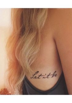 a woman with a tattoo on her back saying, let it be faith in cursive writing