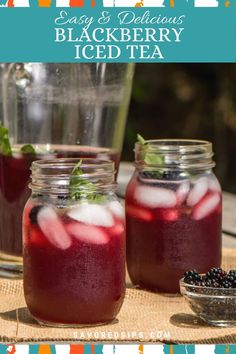 blackberry iced tea in mason jars on a table with berries and mint garnish