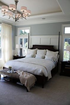 a large bed sitting in a bedroom next to a window