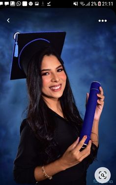 a woman wearing a graduation cap and gown holding a blue diploma scroll in her right hand