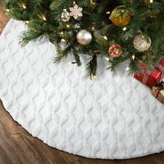 a christmas tree skirt with ornaments on it