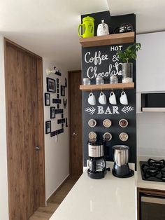 there is a coffee and chocolate bar sign on the wall in this kitchen with white countertops