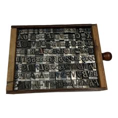 a wooden tray with letters and numbers on it