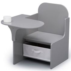 a small desk with a cup on it and some drawers under the table next to it