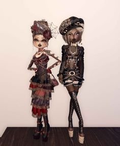 two dolls are standing next to each other