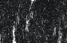 black and white photograph of rain falling down