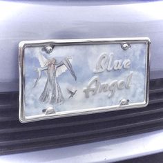 an angel license plate on the front of a car