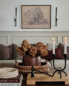 a living room filled with furniture and candles