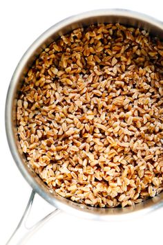 a pot filled with brown rice on top of a white table