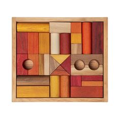 a wooden puzzle with several different shapes and colors on it's sides, including two circles