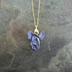 Our Iris flower necklace adds elegance to any outfit and make a fabulous Valentines gift for a flower lover. Each necklace is hand finished in blue enamel. This beautiful necklace embodies nature with its intricate realistic design and attention to detail. Designed by us, in our London office. The Iris is a symbol of hope, wisdom, trust and valor. Irises make fabulous gifts for nature lovers, they are the birth flower for the month of February, the gift to give for a 25th wedding anniversary and perfect for any occasion.  Size: (W) 21mm x (L) 32mm x (drop) 48.5cm Metal colour: gold Necklace clasp: lobster Chain length: 41cm chain with 7.5cm extension chain Each item is presented on a recycled paper gift card (as shown), packed in a biodegradable bag and then placed in an eco-friendly envel Violet Flower Necklace, Blue Flower Charm Jewelry As Gift For Her, Birth Flower Jewelry, Blue Flower-shaped Jewelry For Her, Blue Flower Charm Necklace As Gift, Blue Flower Shaped Necklace Gift, Blue Flower Necklace Gift, Blue Flower Necklace For Gifts, Blue Flower Necklace As Gift For Her