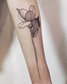 a single flower tattoo on the arm