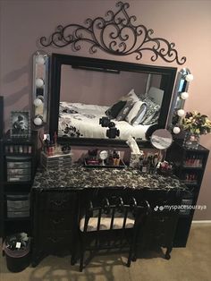 a bedroom with a vanity and mirror in it