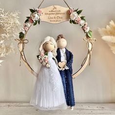 a wedding cake topper in the shape of two people