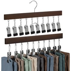 a coat rack with several pairs of pants hanging from it's hooks and clips