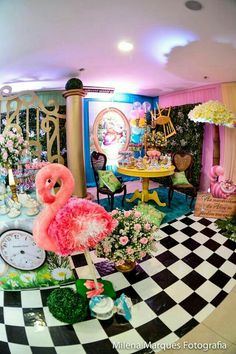 an elaborately decorated living room with pink flamingos and green plants on the floor