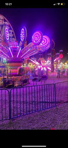 an amusement park at night with many rides