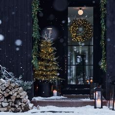 the front door is decorated with christmas lights and wreaths