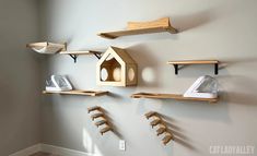 some shelves are hanging on the wall with shoes and other items in them that is made out of wood