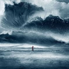 a man standing on top of a beach under a large wave in the ocean with words he's in control