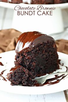 a piece of chocolate brownie bundt cake on a white plate with a fork