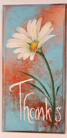 a painting of a white flower with the words thanks painted on it's side