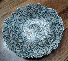 a blue and white plate sitting on top of a wooden table