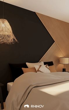 a bedroom with black walls and beige bedding