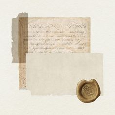 an old paper with a wax stamp on it next to a piece of parchment and a seal